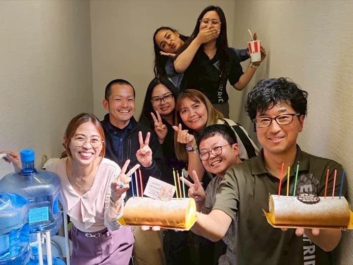 Staff enjoying with a birthday cake